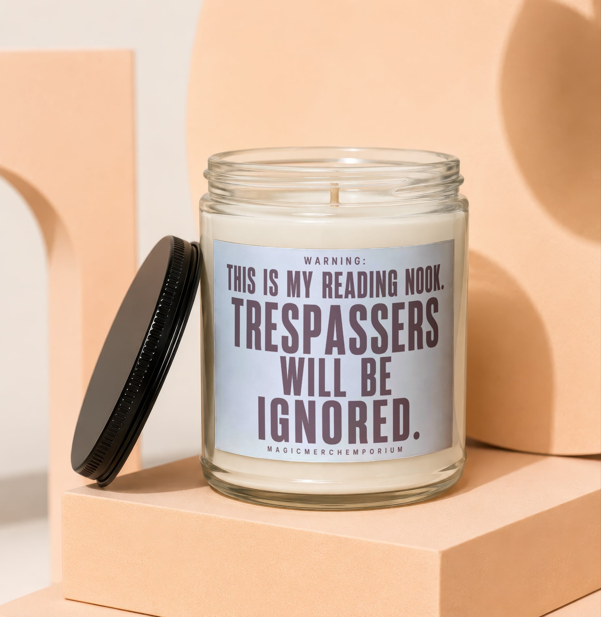 Glass candle with black lid features text: "WARNING: THIS IS MY READING NOOK. TRESPASSERS WILL BE IGNORED."