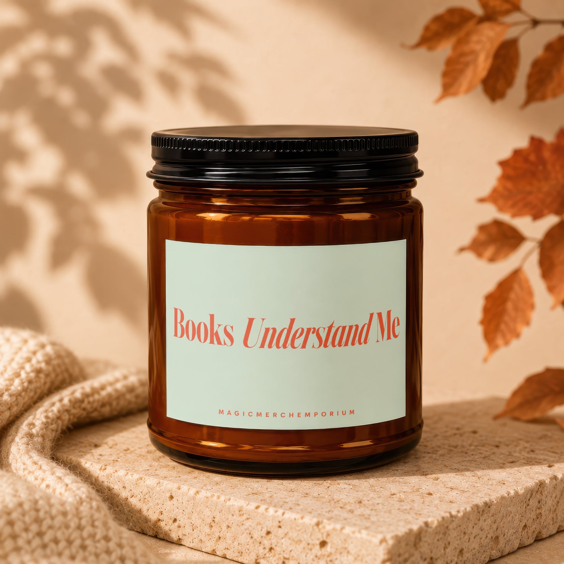 Amber jar candle with black lid displaying "Books Understand Me" text.