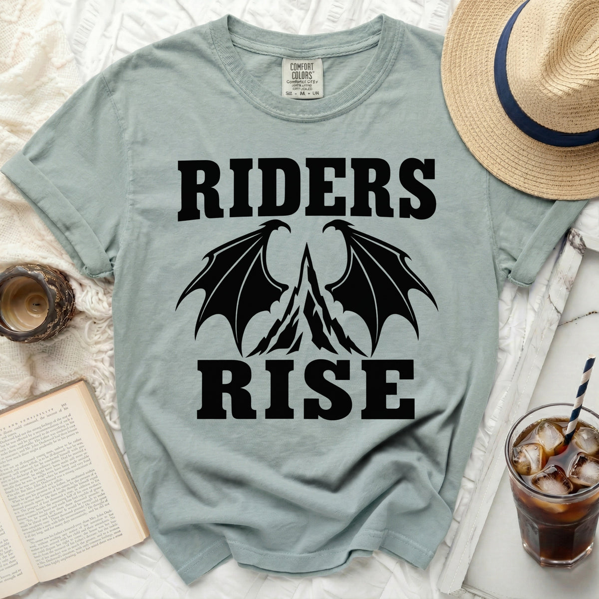 T-shirt with black dragon wings and text "RIDERS RISE" and Comfort Colors tag.
