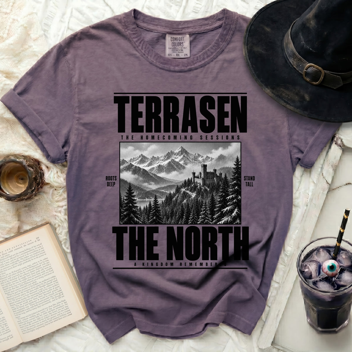Purple t-shirt with "Terrasen The Homecoming Sessions The North A Kingdom Remembered" graphic.