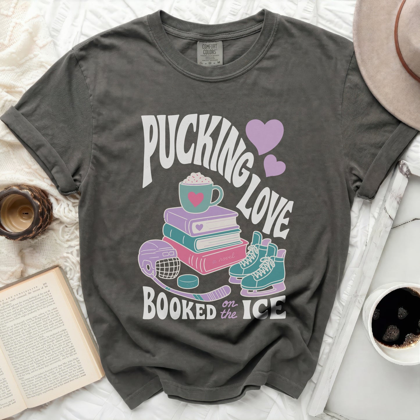 Dark gray Comfort Colors t-shirt with "Pucking Love Booked on the Ice" graphic.