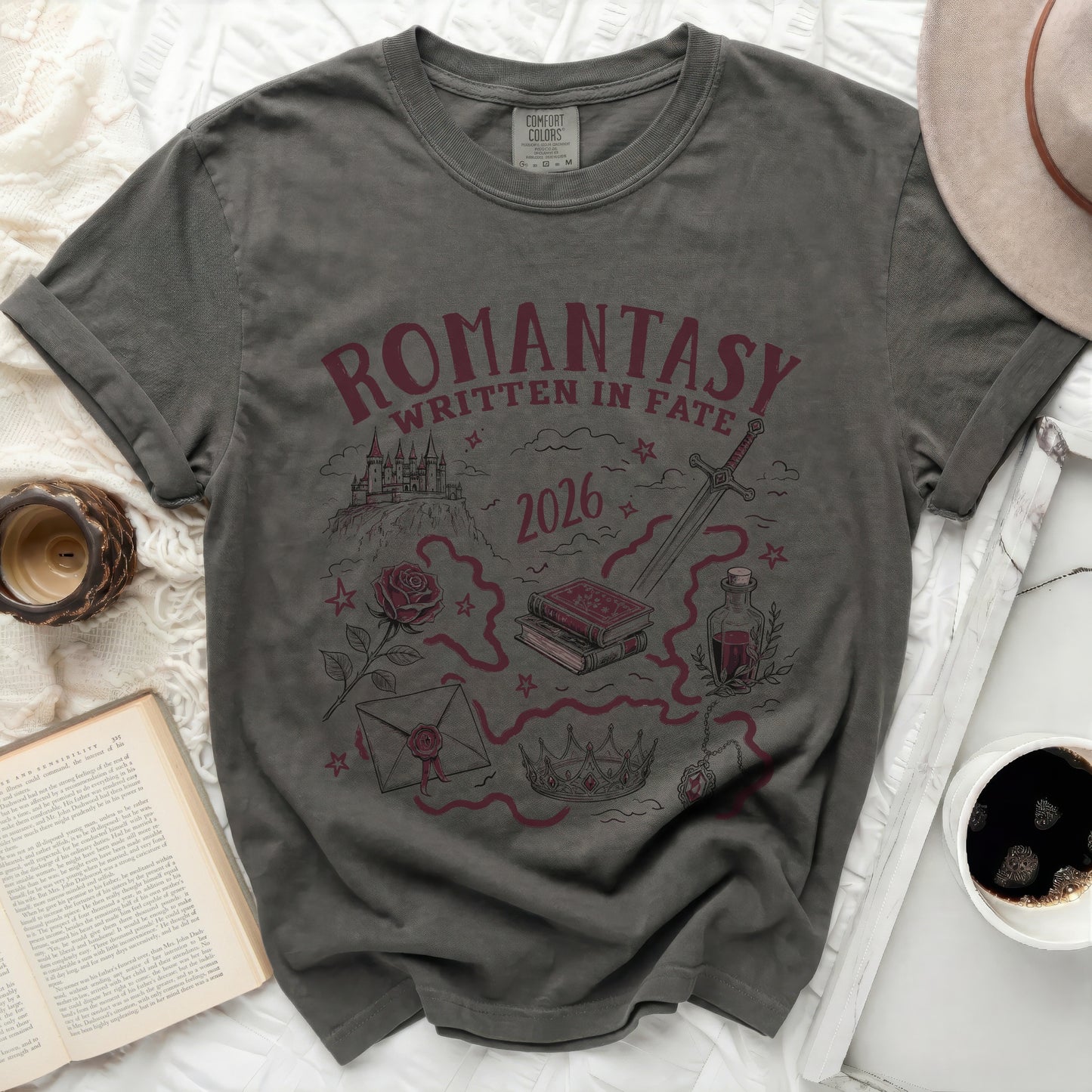 Dark grey t-shirt with "Romantasy Written in Fate 2026" and fantasy illustrations.