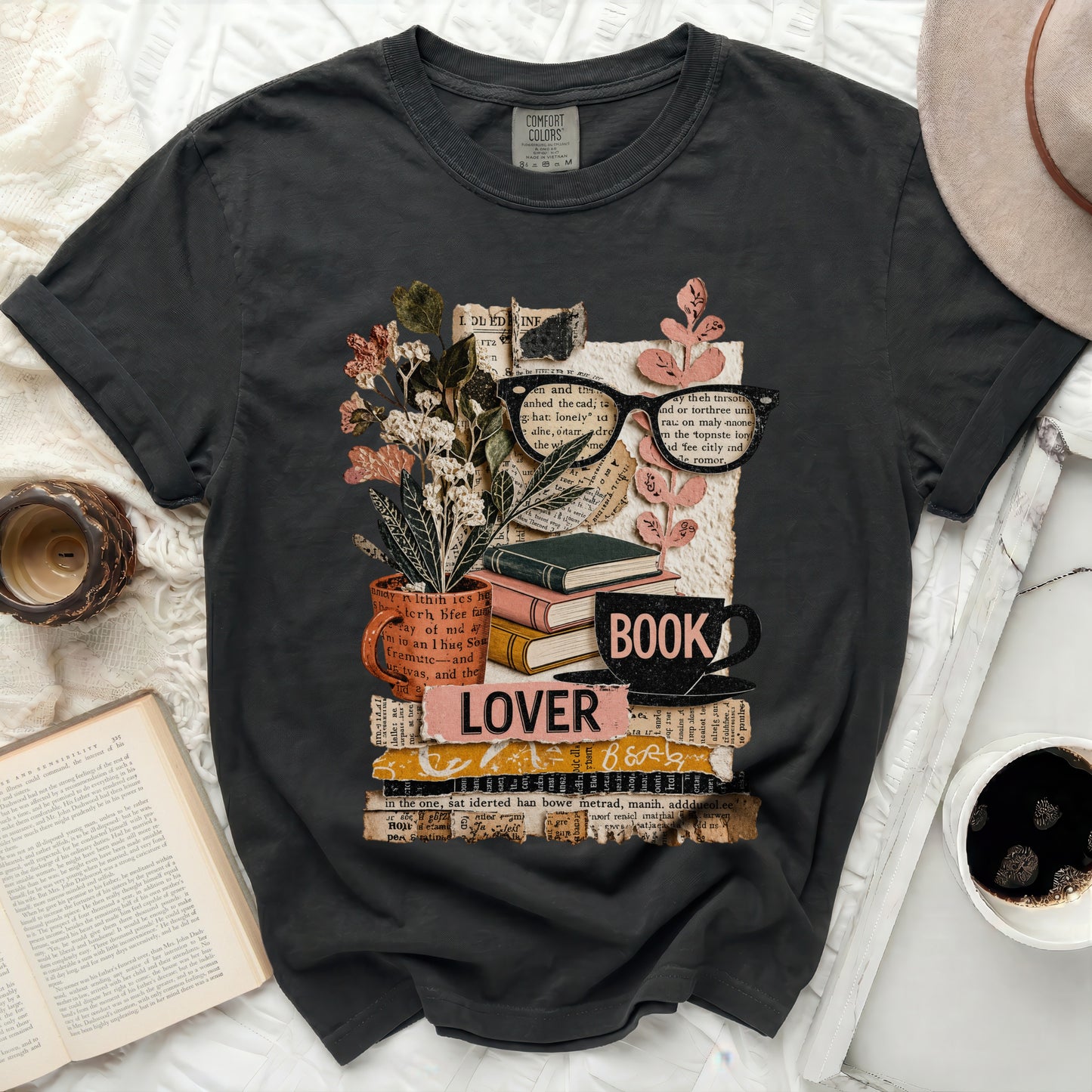 Graphic tee with stack of books, glasses, flowers, and "LOVER BOOK" text.