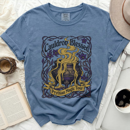Blue t-shirt with "Cauldron Blessed Prythian Magic Tour" graphic.