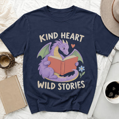 Navy t-shirt with purple dragon reading book, text "Kind Heart Wild Stories".