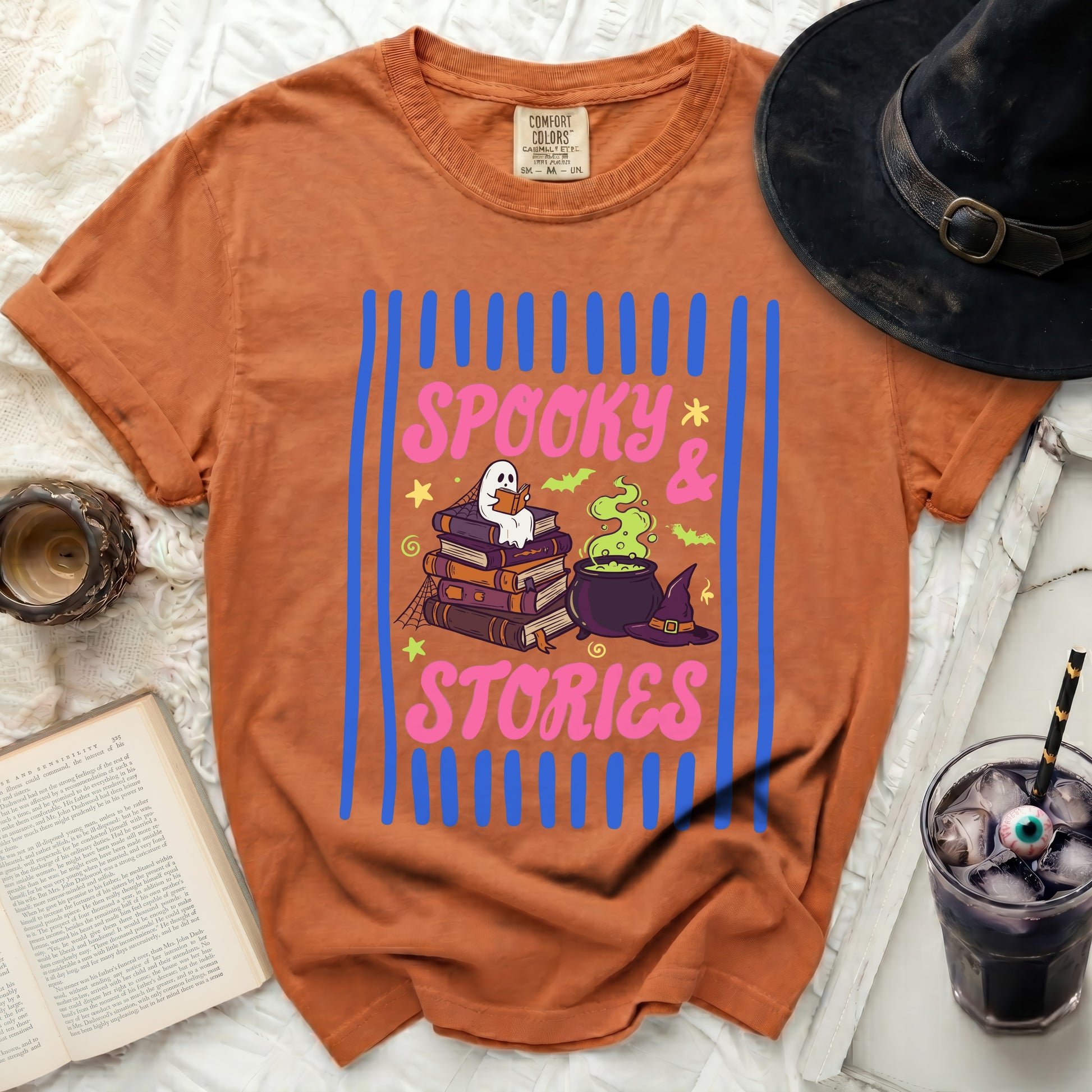 Orange t-shirt with "Spooky & Stories" and ghost reading books design.