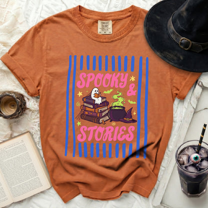 Orange t-shirt with "Spooky & Stories" and ghost reading books design.