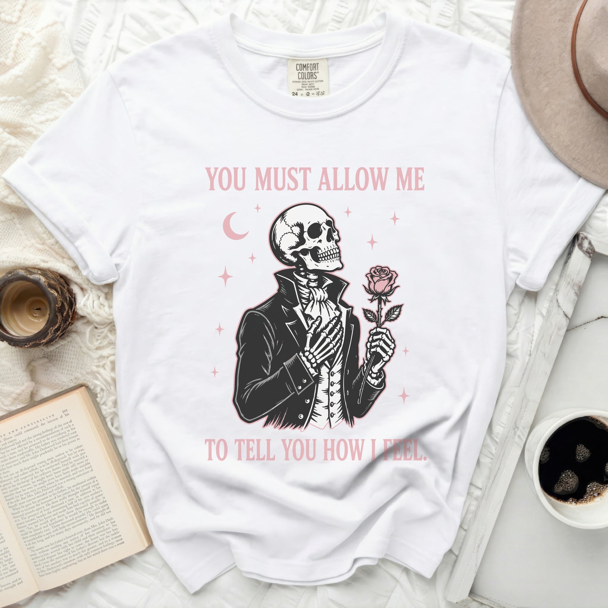 White t-shirt with a skeleton holding a rose, text reads "YOU MUST ALLOW ME TO TELL YOU HOW I FEEL."