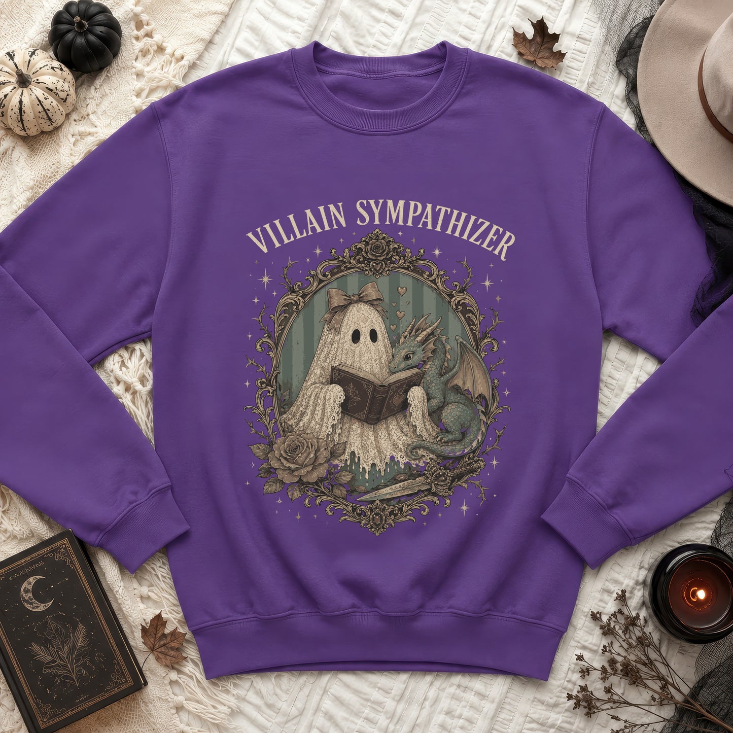 Purple sweatshirt with a ghost and dragon reading a book, text reads "VILLAIN SYMPATHIZER".