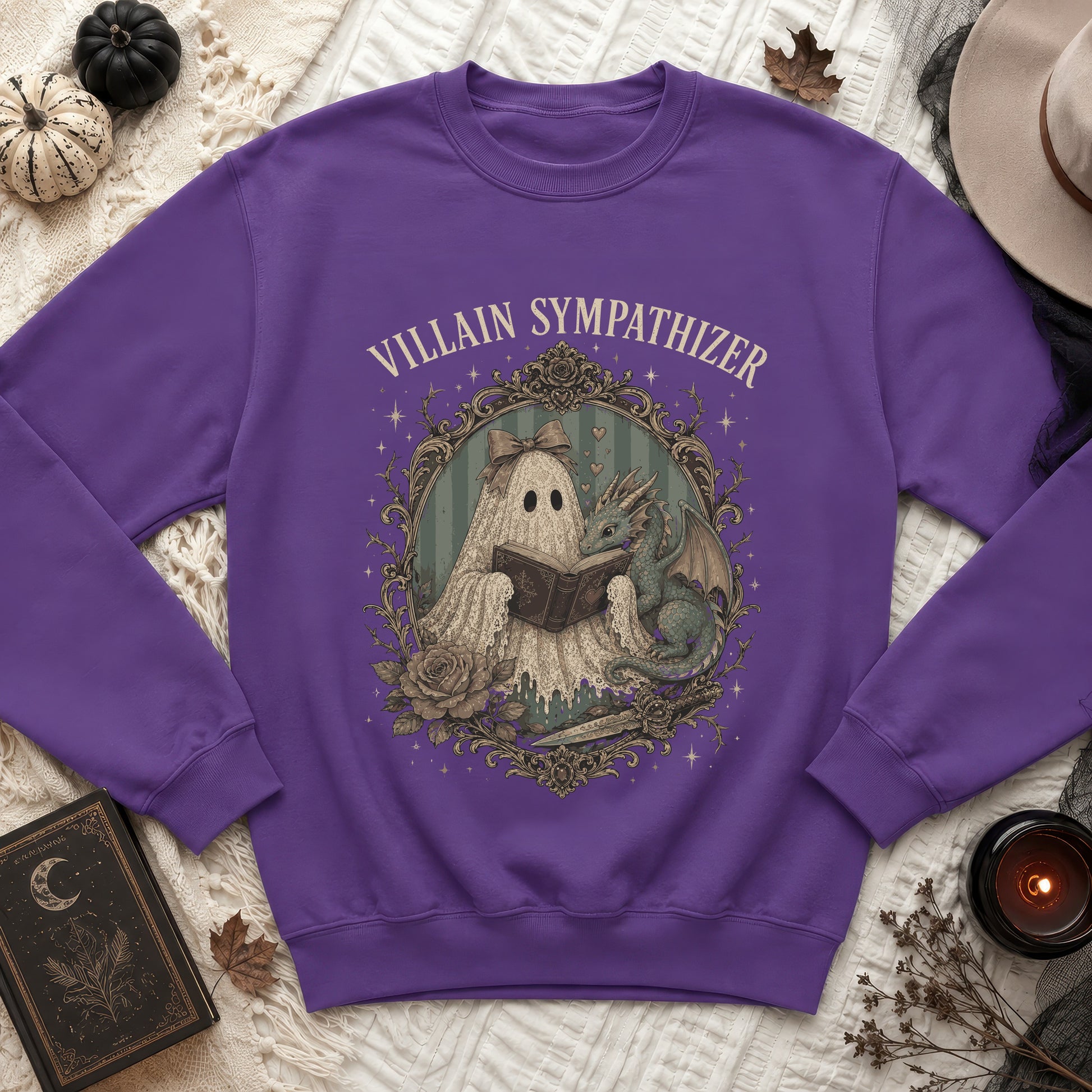 Purple sweatshirt with a ghost and dragon reading a book, text reads "VILLAIN SYMPATHIZER".