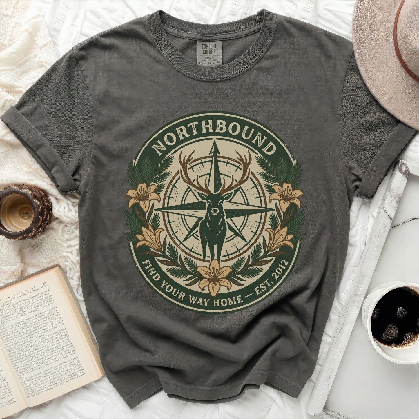 Dark grey t-shirt with a compass, deer, and floral design.