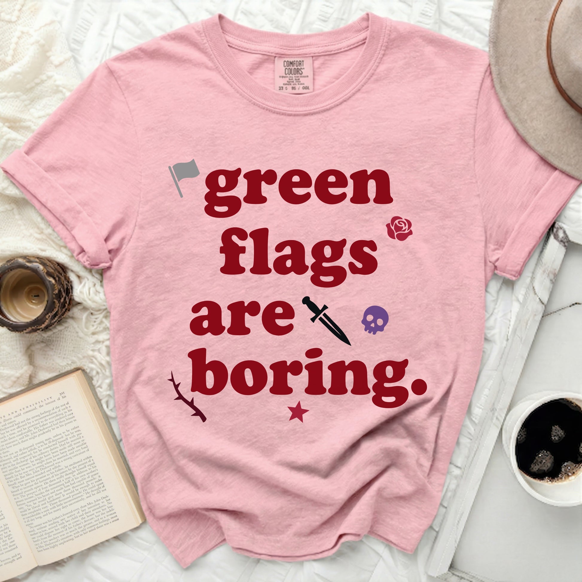 Pink t-shirt with "green flags are boring" and decorative icons.