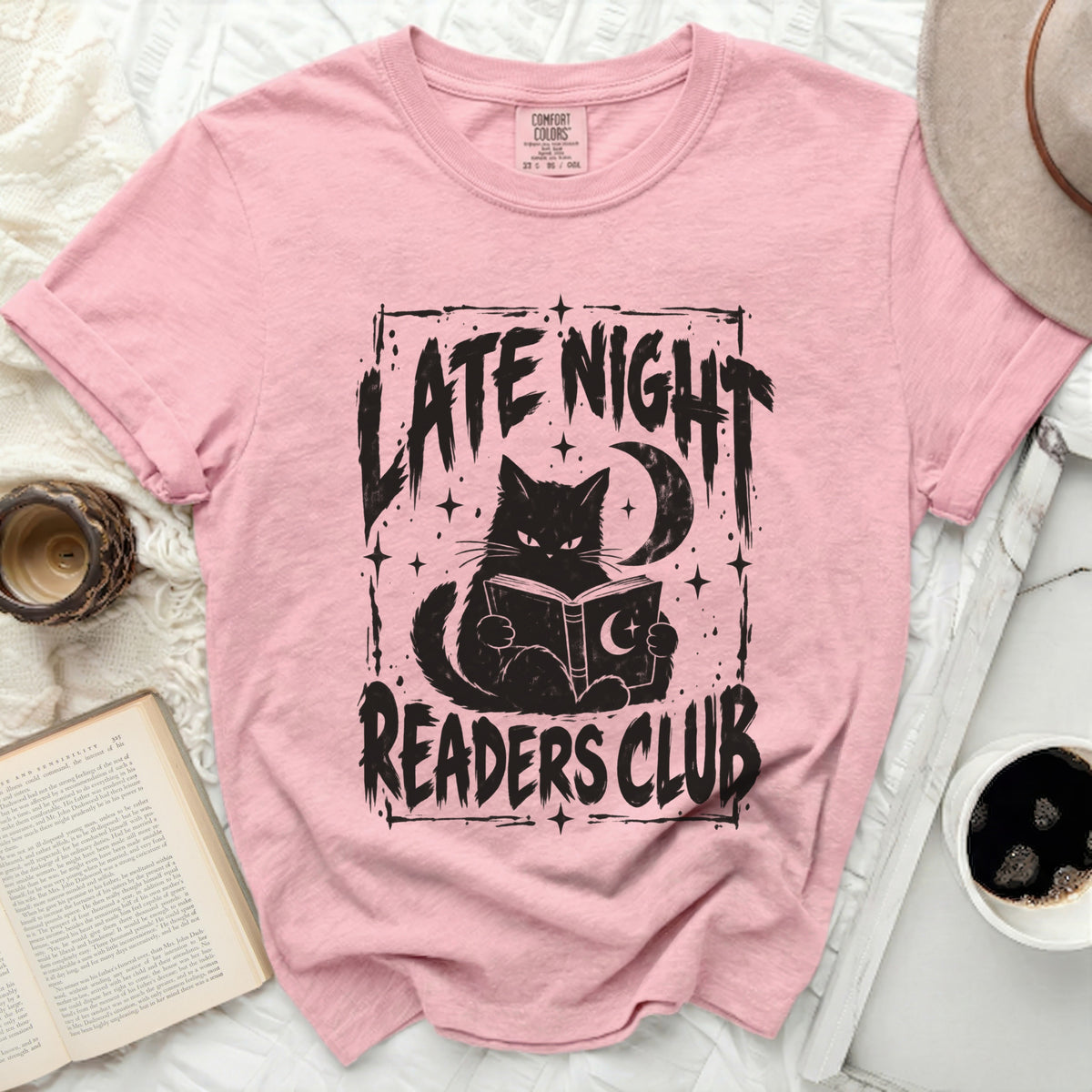 Pink t-shirt with black graphic of a cat reading a book, "LATE NIGHT READERS CLUB".