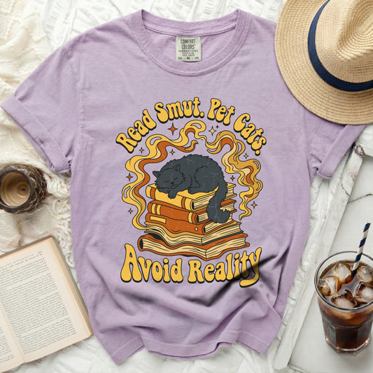 Purple t-shirt with "Read Smut. Pet Cats. Avoid Reality." text and sleeping cat.