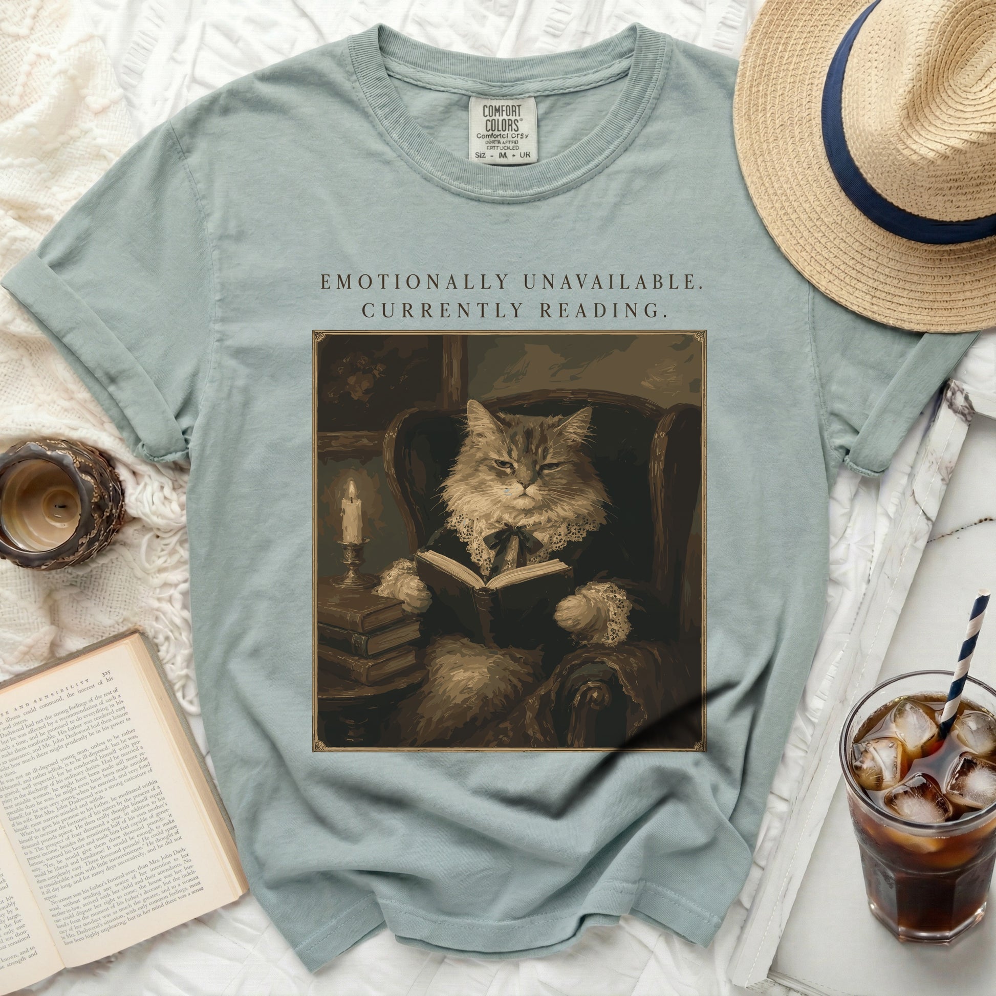 "Emotionally Unavailable. Currently Reading." text on a vintage-style cat graphic t-shirt.