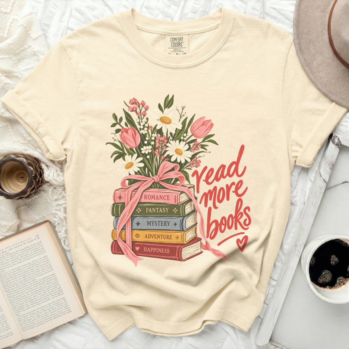 Cream t-shirt with stacked books and floral illustration reading "read more books".