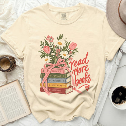 Cream t-shirt with stacked books and floral illustration reading "read more books".