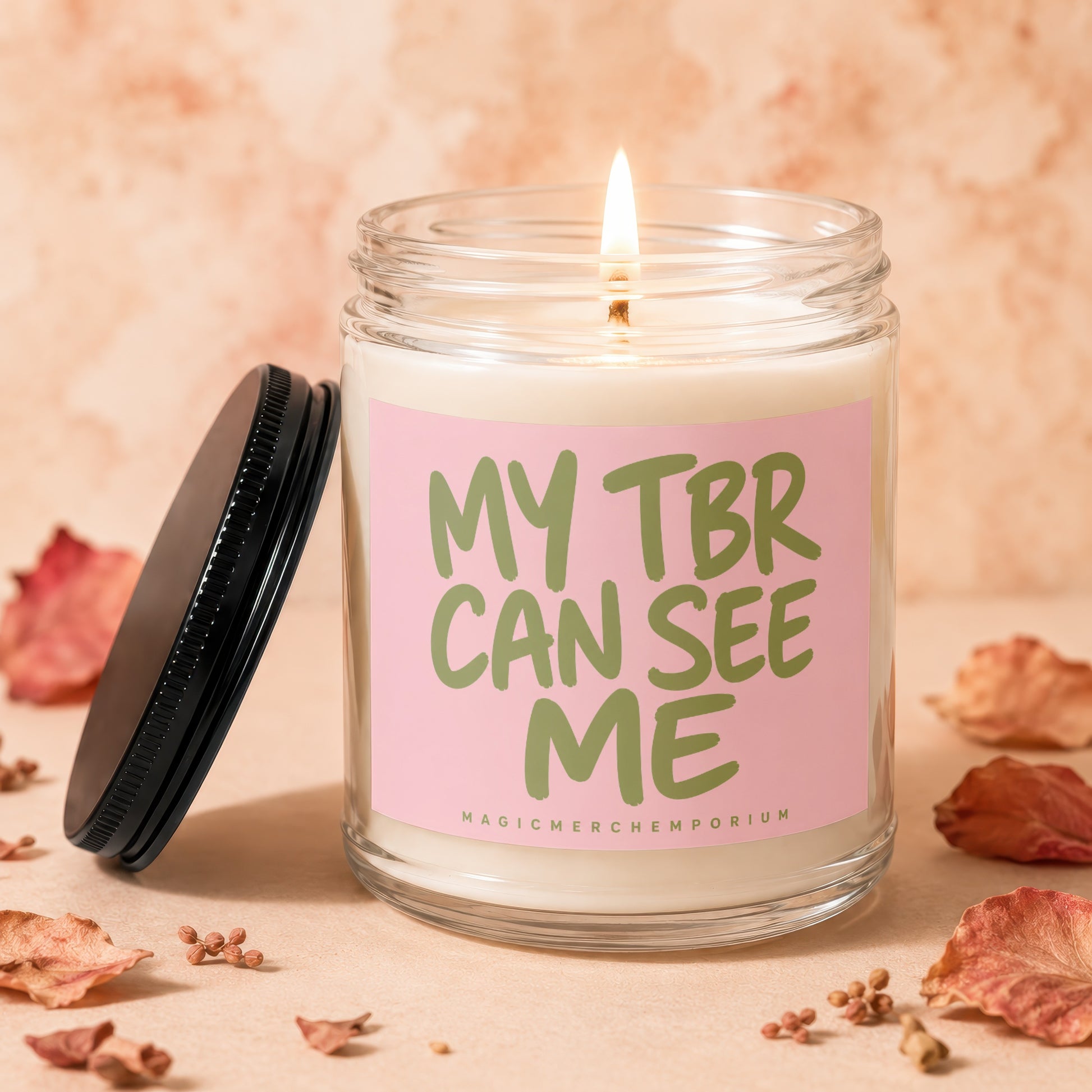 Candle with a pink label that reads "MY TBR CAN SEE ME".