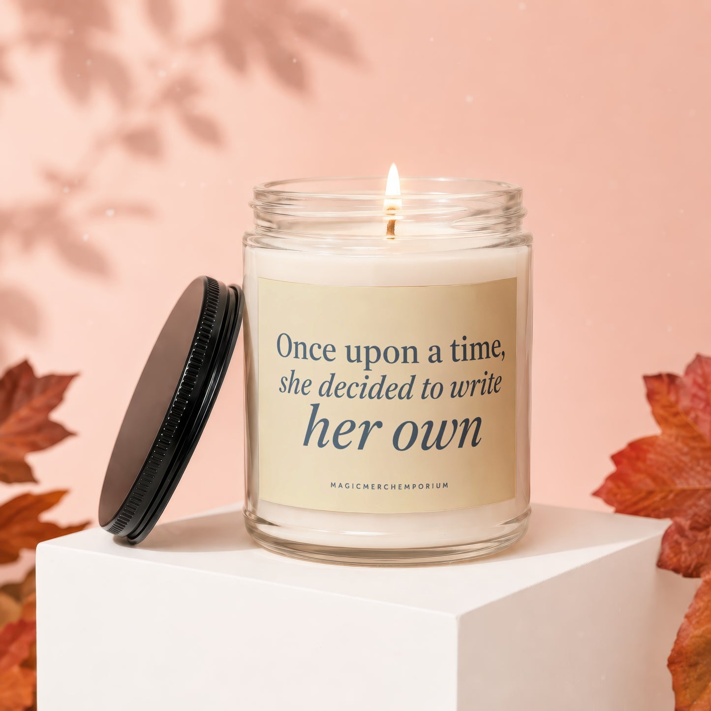 Lit candle in jar with label "Once upon a time, she decided to write her own."