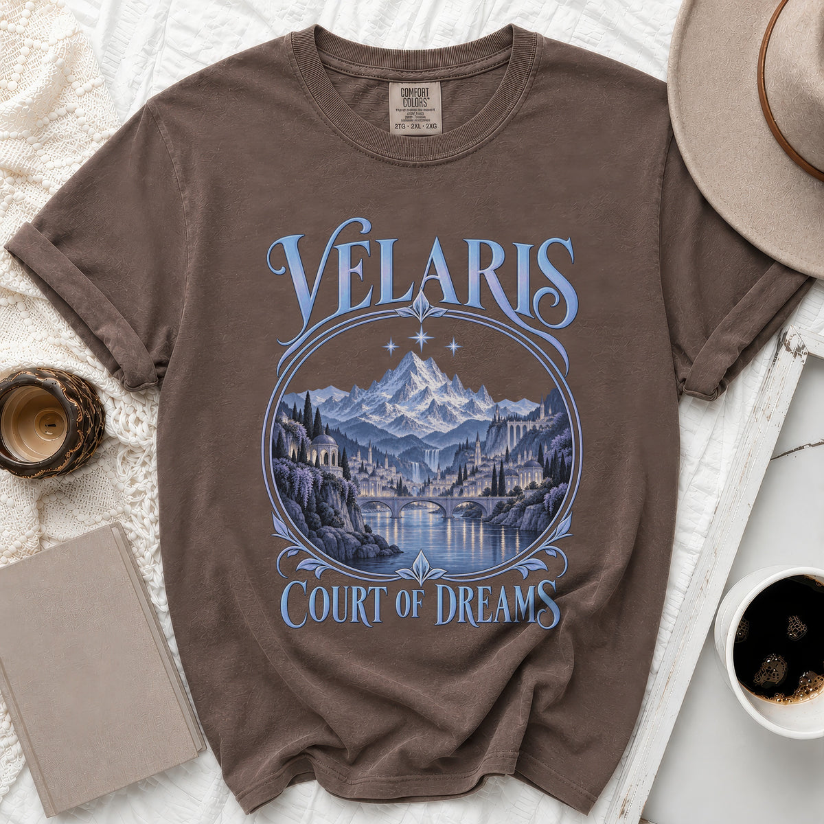 Brown t-shirt with "Velaris Court of Dreams" text and a city landscape.