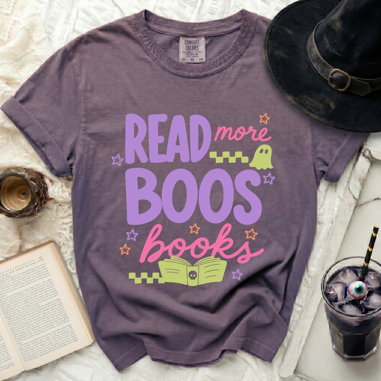 Purple Comfort Colors t-shirt with "Read more Boos Books" Halloween graphic.