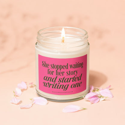 Candle with pink label reading "She stopped waiting for her story and started writing one."