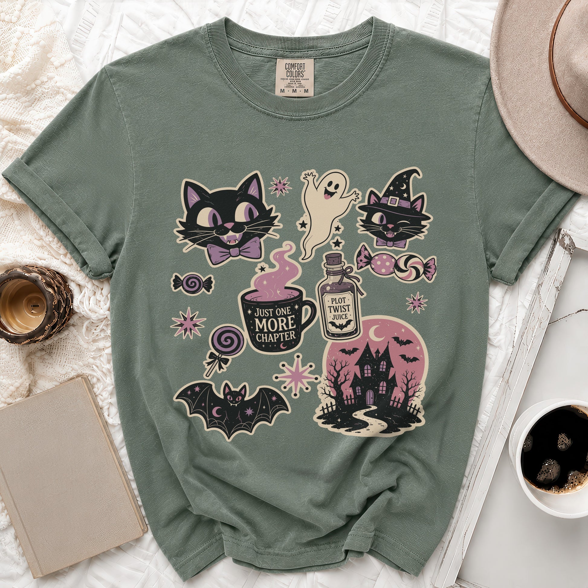 T-shirt with Halloween-themed graphics including cats, ghost, haunted house, and potion.