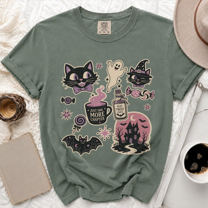 T-shirt with Halloween-themed graphics including cats, ghost, haunted house, and potion.