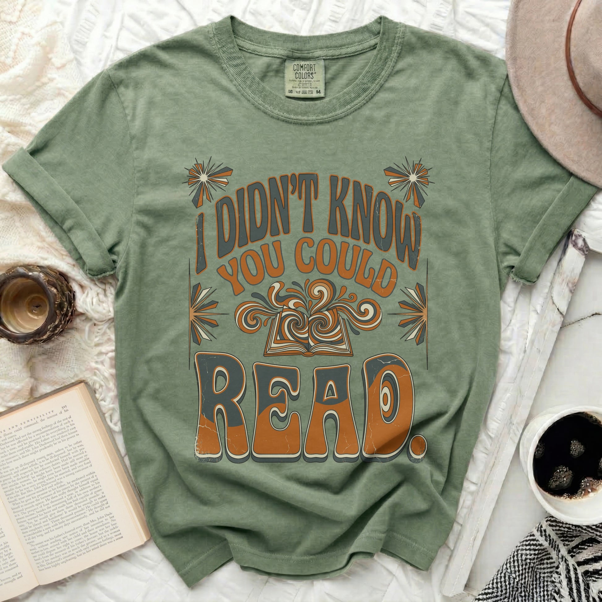 Green t-shirt with "I didn't know you could read" and an open book graphic.