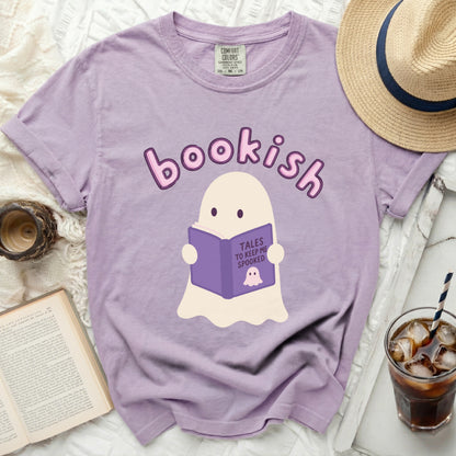 Lavender t-shirt with a cartoon ghost reading a book titled "Tales to Keep Me Spooked."