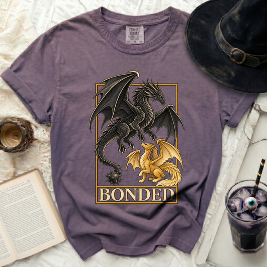 Purple t-shirt with black and gold dragons and the word BONDED.