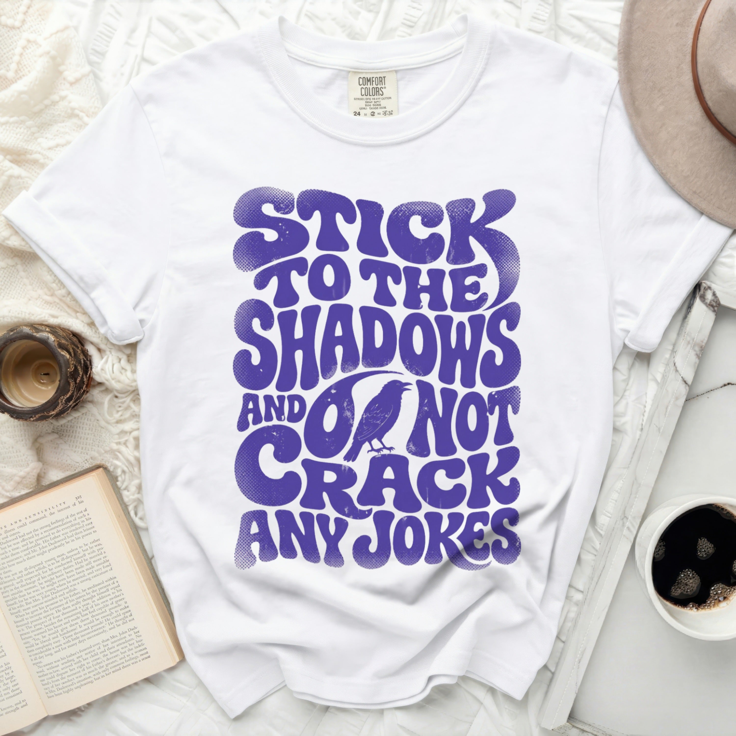 White t-shirt with purple text 
