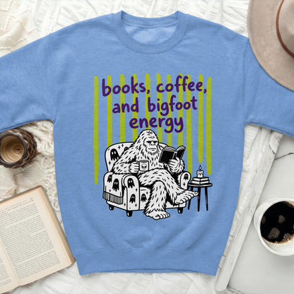 Bigfoot reading a book and drinking coffee with "books, coffee, and bigfoot energy" text.