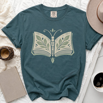 Teal Comfort Colors t-shirt with open book butterfly graphic and size XL tag.