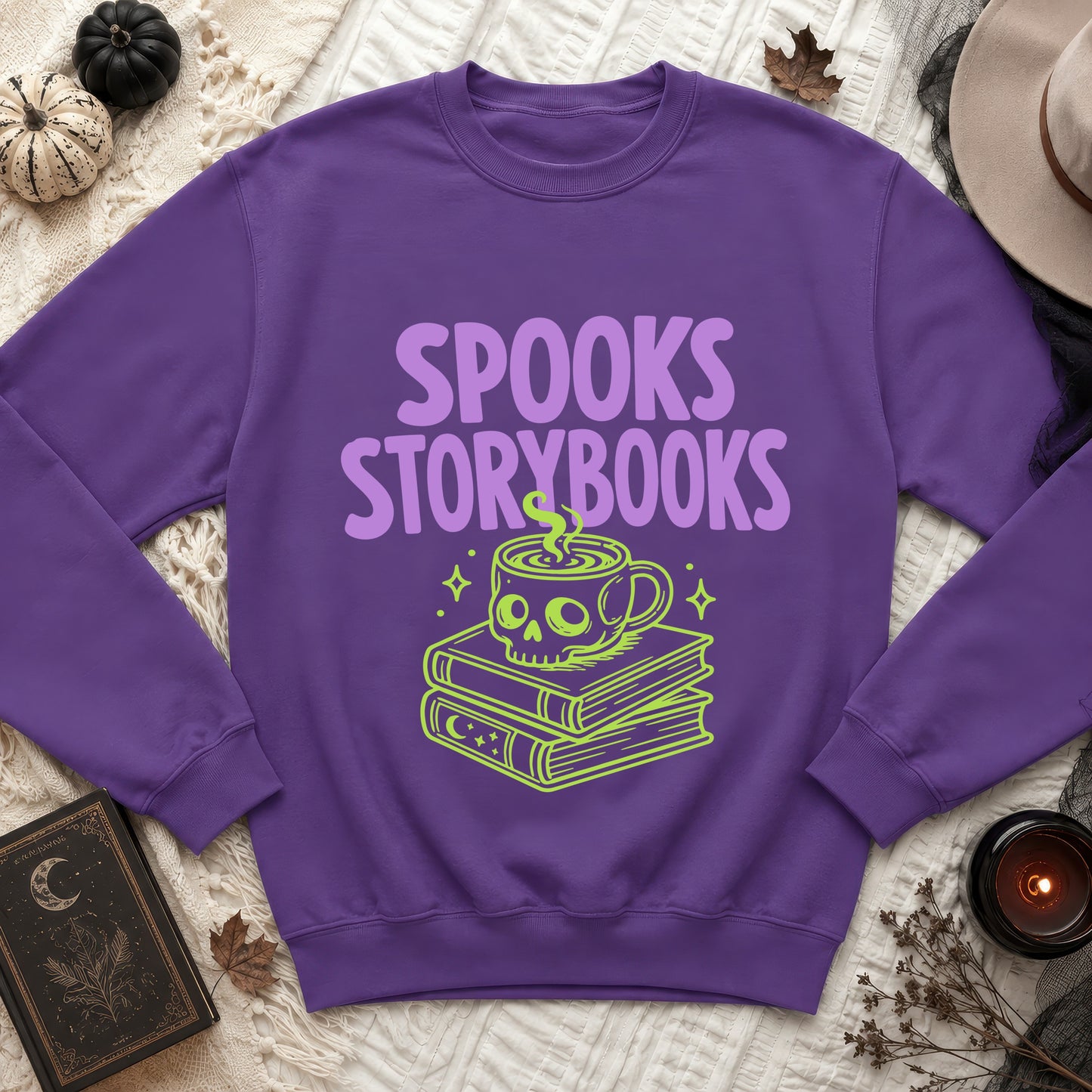 Purple sweatshirt with "Spooks Storybooks" text and a skull coffee cup on books design.