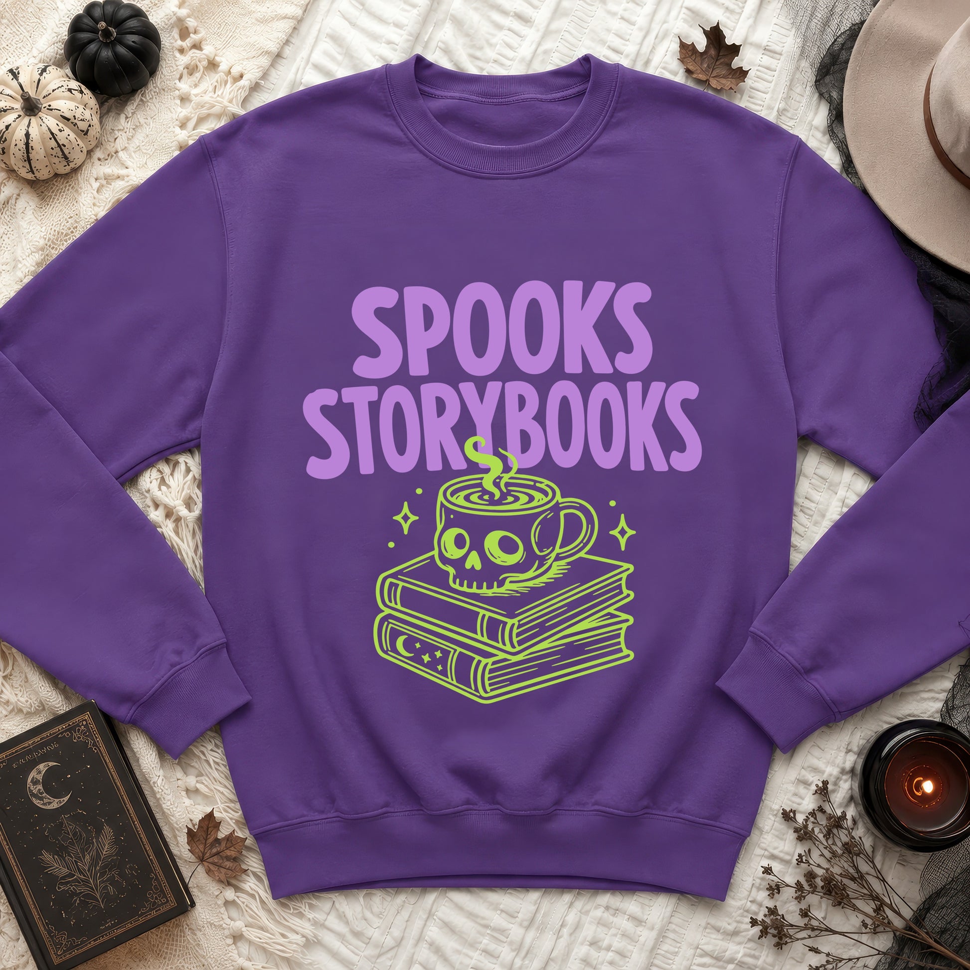 Purple sweatshirt with "Spooks Storybooks" text and a skull coffee cup on books design.
