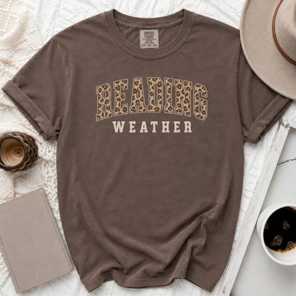 Brown t-shirt with "READING WEATHER" text in leopard print and block letters.