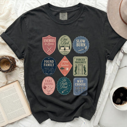 Black t-shirt with nine romance novel-themed graphic badges.