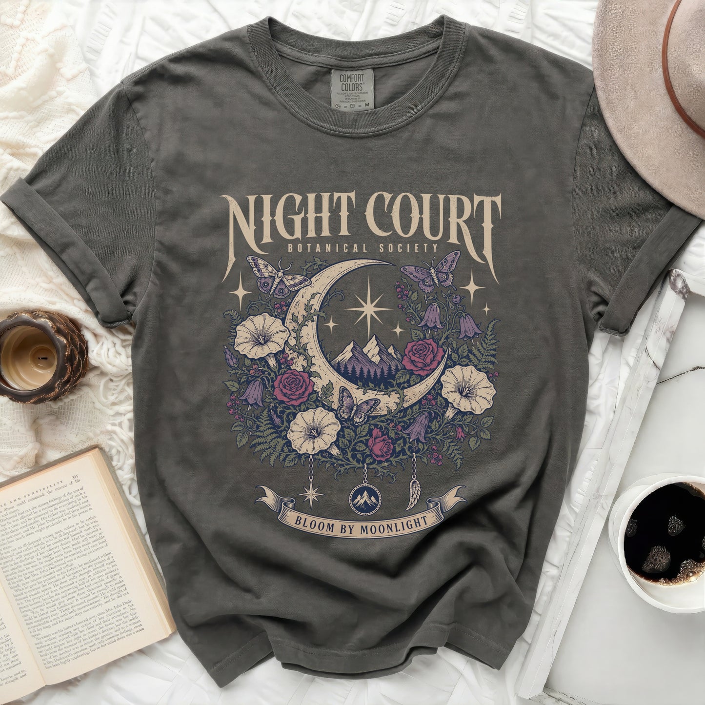 Dark grey t-shirt with moon, floral, and butterfly graphic that says "Night Court Botanical Society Bloom By Moonlight".