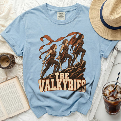 The Valkyries graphic on a light blue t-shirt with women warriors and swords.