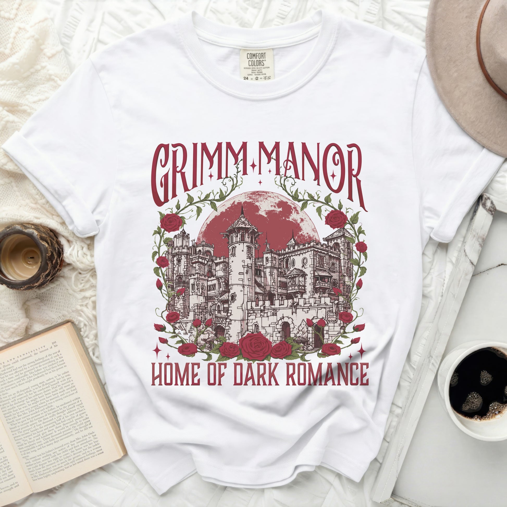 White t-shirt with "Grimm Manor Home of Dark Romance" graphic.