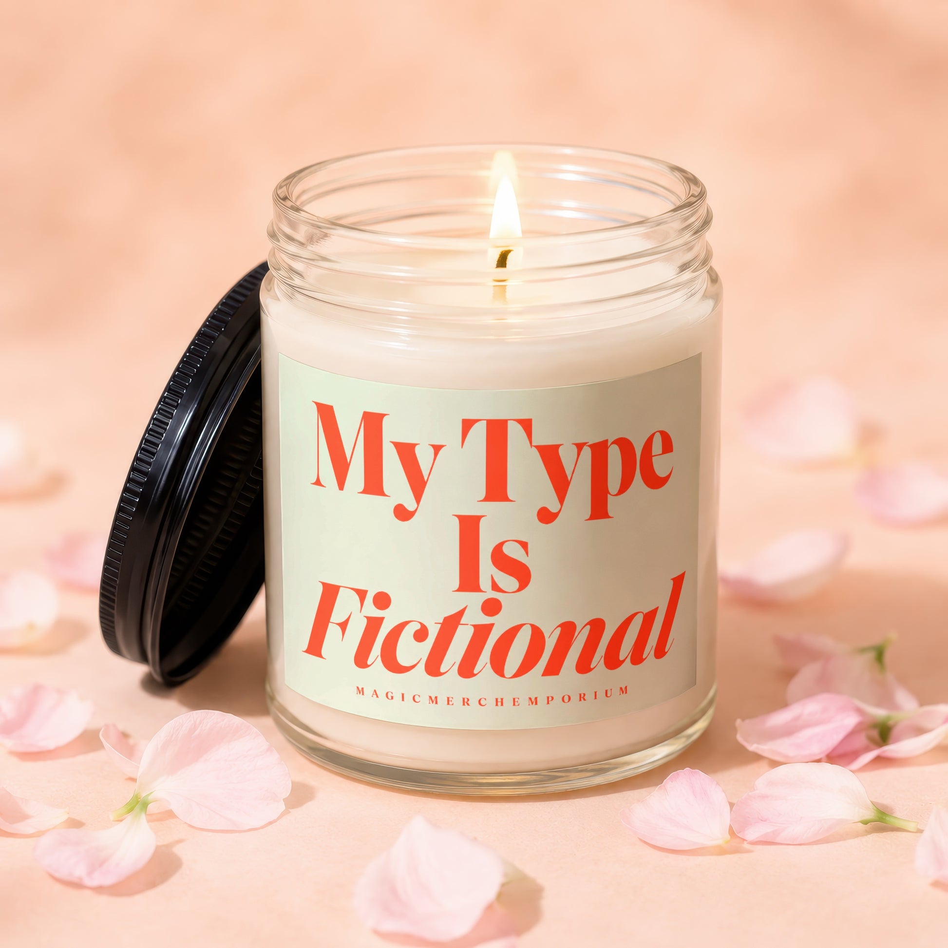 Lit candle in glass jar with "My Type Is Fictional" text and scattered petals.
