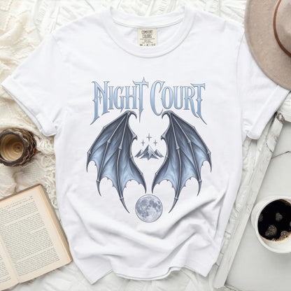 White t-shirt with "Night Court" text, bat wings, mountains, and moon graphic.