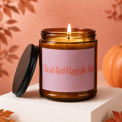 Amber candle with pink label reading "I Read Red Flags for Fun"