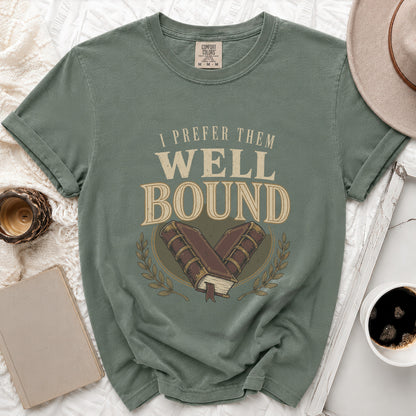 Green t-shirt with "I prefer them WELL BOUND" text and vintage books graphic.