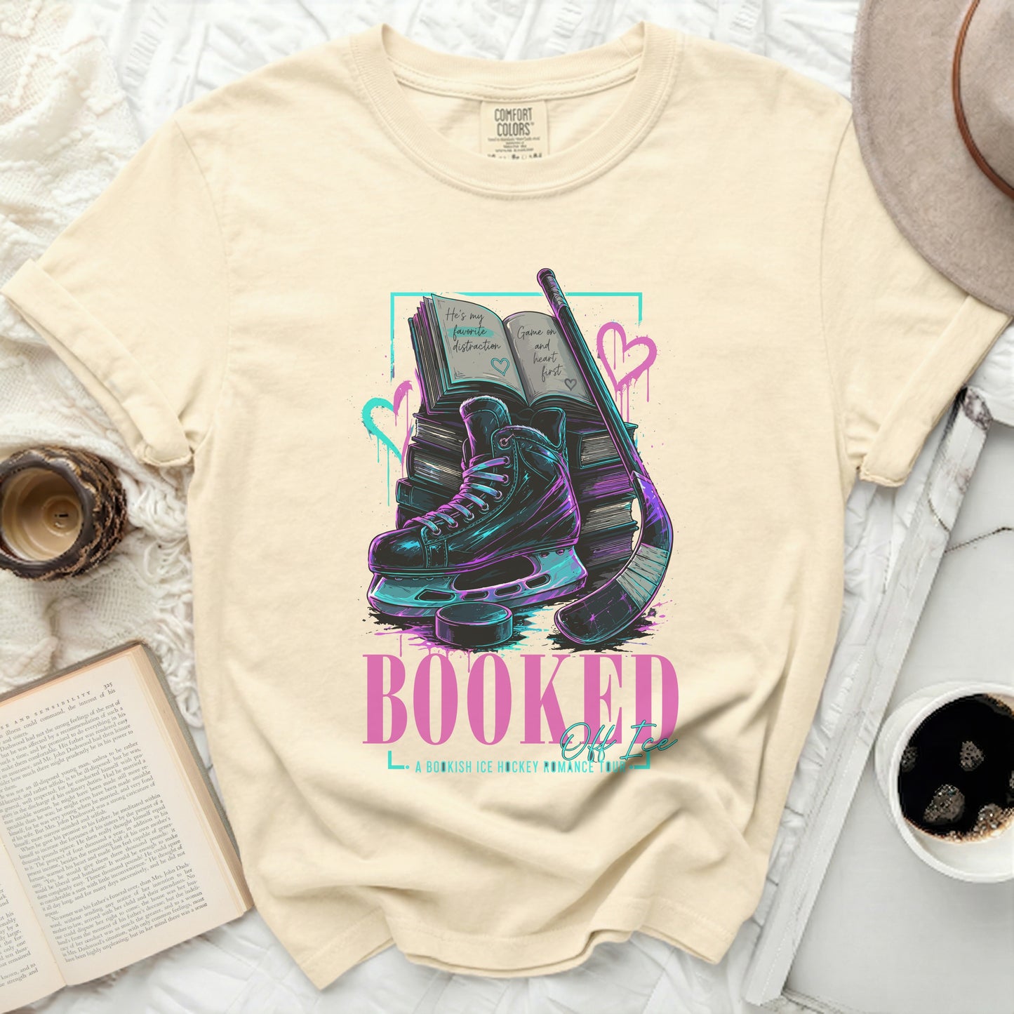 T-shirt with Booked for Life text, ice skates, hockey stick, and books.