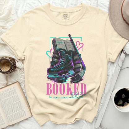 T-shirt with Booked for Life text, ice skates, hockey stick, and books.