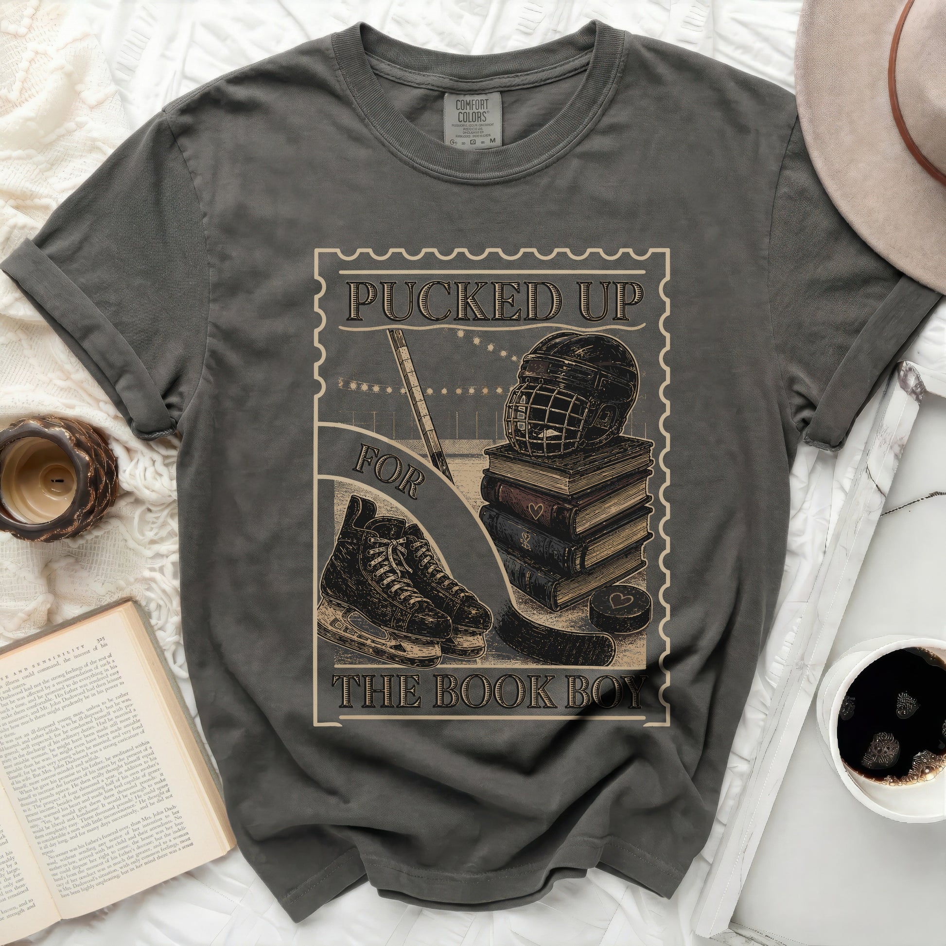 Dark t-shirt with "Pucked Up for the Book Boy" text and hockey imagery.