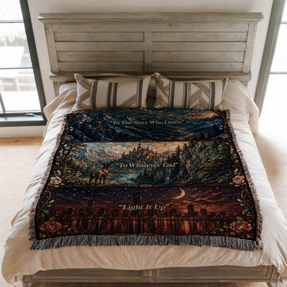 a bed with a colorful, patterned blanket that has a mountain landscape design. The blanket is spread out on the bed, covering the entire surface.