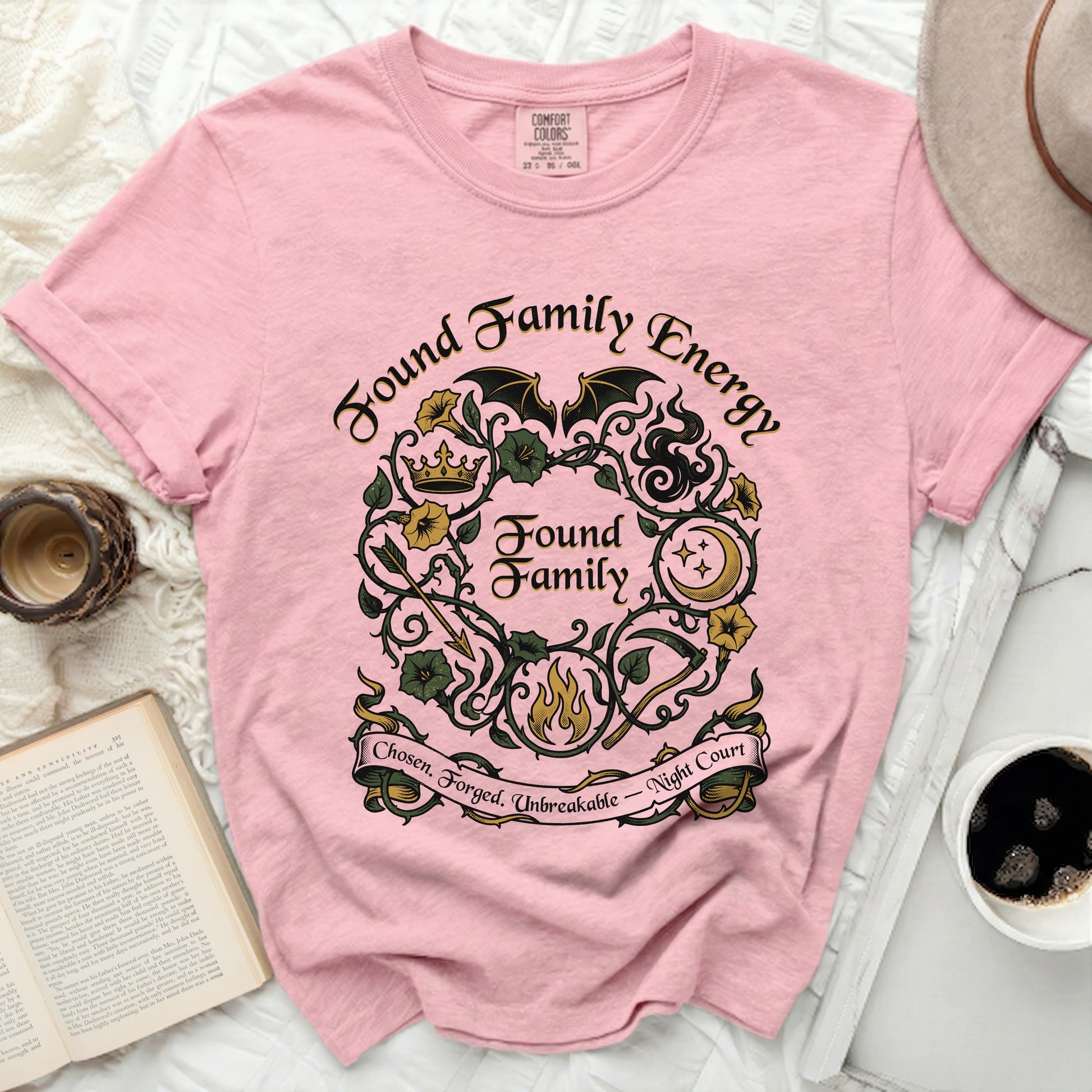 Pink t-shirt with "Found Family Energy" and wreath design.
